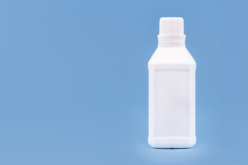Plastic bottle for hydrogen peroxide, blue background, medicine concept, with copy space
