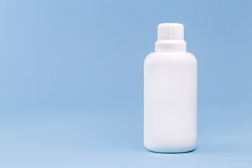 Plastic bottle for hydrogen peroxide, blue background, medicine concept, with copy space