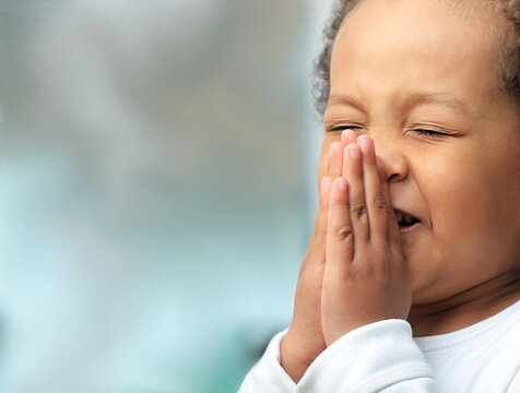 boy praying to God with hands together on white background stock photo  