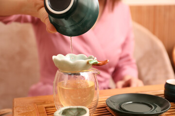 Master conducting traditional tea ceremony at table, closeup