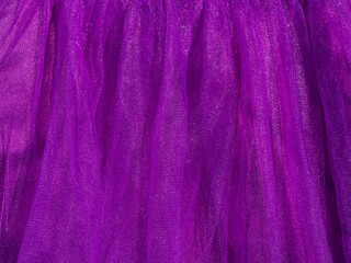 Purple tulle fabric texture top view. Violet background. Fashion trendy color feminine tutu skirt dress flat lay, female blog glossy backdrop text sign design. Girly abstract wallpaper,textile surface