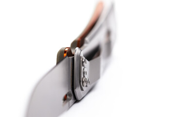 A small folding hunting knife isolated on the white background. Photo taken under soft artificial light.