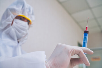 Scientist test a vaccine in syringe before inject to patient for protect covid-19 or other sickness