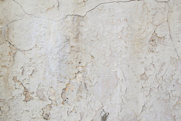 Old textured backdrop wall. Cracks, delamination. Grey colour.
