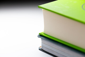 Details of green hardcover books isolated on white background. Photo taken under artificial...