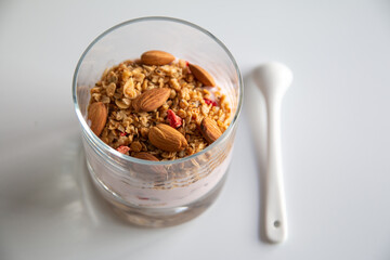 Isolated photo of diet yogurt with granola and almond, healthy breakfast concept 