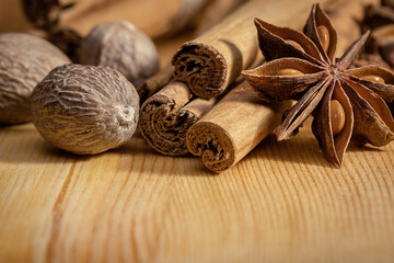 A set of spices for cooking, nutmeg, anise and cinnamon sticks. Indian cuisine, copy space.