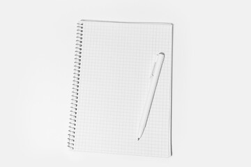Close-up of empty notebook and pen, isolated on white background. Top view.