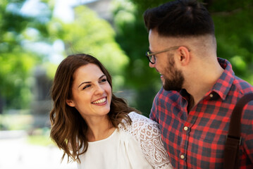 Fototapeta premium Happy young couple outdoors. Loving couple walking in the city