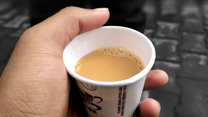 boy holding a cup of tea in the morning upon waking up