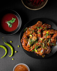 chicken chilly spicy in plate top view , chinese starter dish theme or creative photo