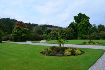 Stunning view of a private garden with white benches