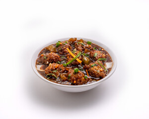 veg Manchurian or Gobi Manchurian in a white bowl on white and dark background