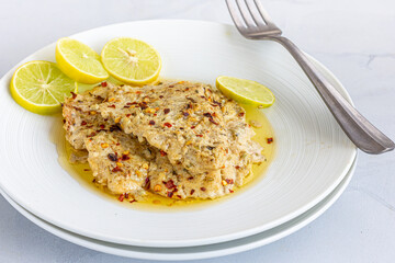 Baked Fish in Butter Sauce with Lemon Close Up Photo