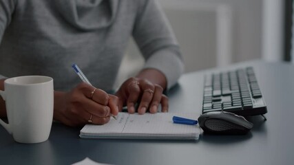 African american student writing high school homework on notebook working remote from home. Black woman studying math using elearning univeristy platform during online courses sitting at desk - Powered by Adobe