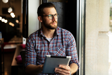 Young businessman using digital tablet in the office. Handsome man learning online