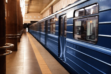 Modern subway station with blue train. Public transport