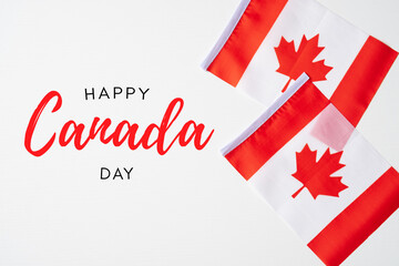 National flags of Canada on white background. Happy Canada Independence Day greeting card template. Flat lay, top view, copy space.