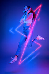 Caucasian woman's portrait isolated on blue studio background in multicolored neon light with...