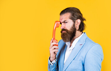 mature bearded male guy looking elegant hold retro phone, connection