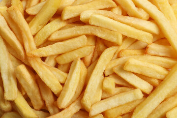 Yummy French fries as background, top view
