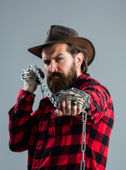 Portrait of masculinity. male casual fashion style. handsome hipster with cowboy hat hold chain