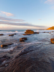 Morning view of the beach with rocky coastline.