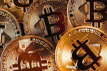Close Up Of A Set Of Golden Bitcoins Stacked Together With Visible Logo.
