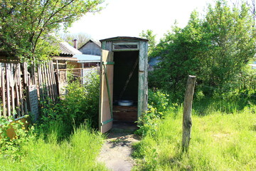 Old wooden rural toilet with open door