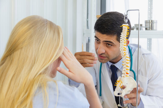 dotor explain bone joint of famale patient at desk in hospital room