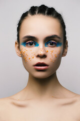 Young model portrait in studio, bright creative make up