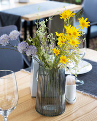 Beautiful bouquet of flowers on a table at the restaurant outdoors