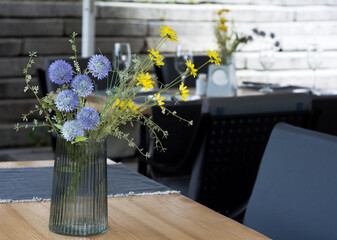 Beautiful bouquet of flowers on a table at the restaurant outdoors
