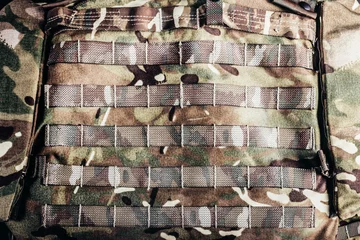 Foto op Canvas Photo of military camouflaged armored vest molle system. © breakermaximus