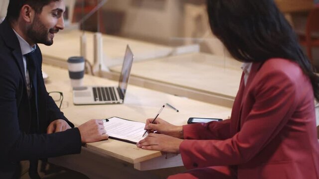 Businessman showing client in office where to sign contract