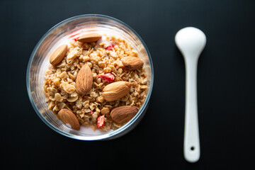 Isolated photo of diet healthy yogurt with granola and almond, breakfast idea with muesli or cereal yogurt