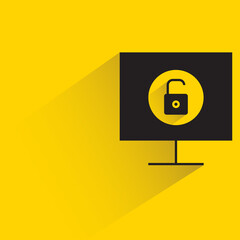 unlock key on desktop computer with shadow on yellow background