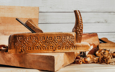 Photo of wooden old fashioned carved planes  laying on workbench table with sawdust.