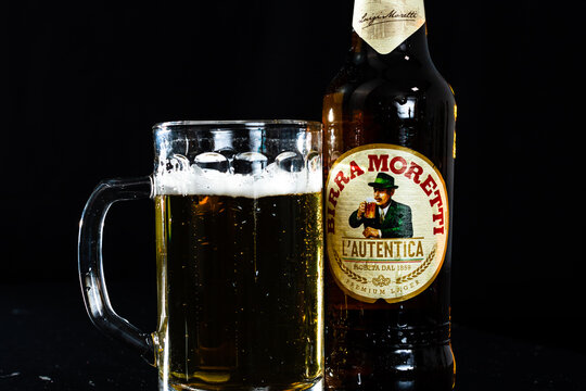 Can of Birra Morreti beer and beer glass on dark background. Illustrative editorial photo shot in Bucharest, Romania, 2021