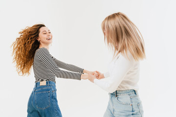 Young white two women making fun and dancing together