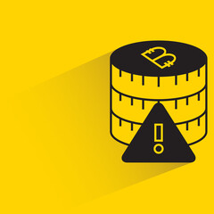 stack of bitcoins and error icon with shadow on yellow background