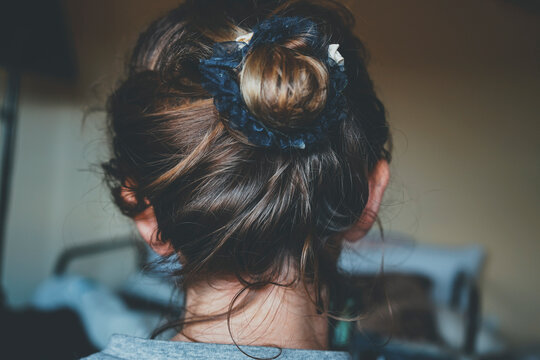 Back view of a comfortly bun hairstyle of a young woman