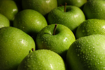Ripe green apples with water drops as background, closeup