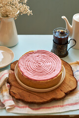 Berry pink cheesecake. Side view, wooden background.