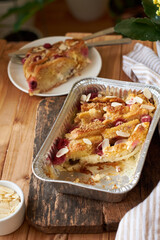 Bread pudding with raspberry. Side view, wooden background.