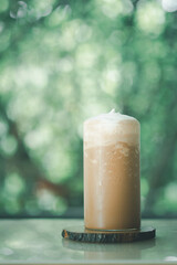 Iced coffee Mocha blended in tall glass placed on wood table