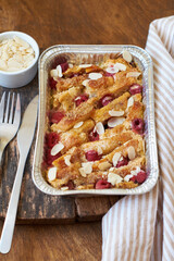 Bread pudding with raspberry. Side view, wooden background.