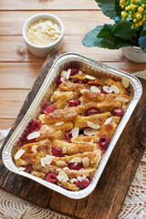 Bread pudding with raspberry. Side view, wooden background.