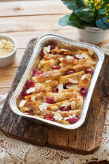 Bread pudding with raspberry. Side view, wooden background.
