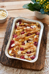 Bread pudding with raspberry. Side view, wooden background.